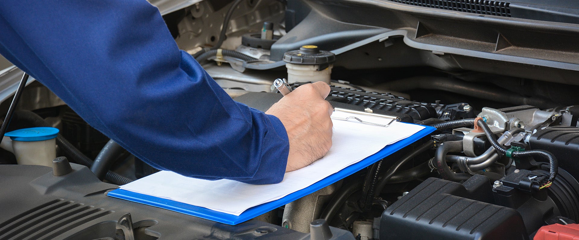 Service technician doing a routine check on vehicle - Rob Green GMC in Twin Falls ID